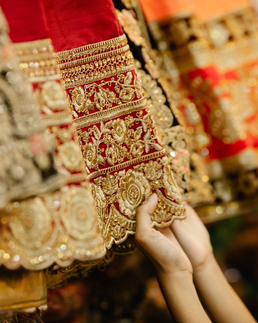 Choosing gold-embroidered fabric at Akheela Shopping Center